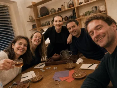 A group of players smiling around a tea table after a game.
