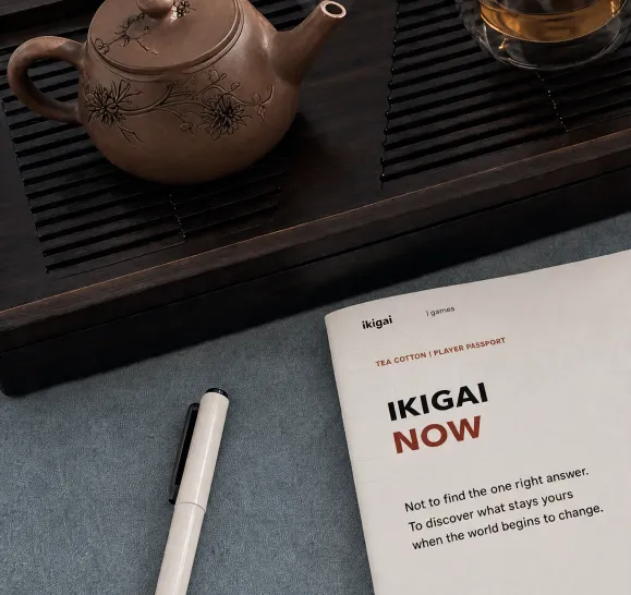 The Ikigai Now player passport on a tea table next to a clay teapot