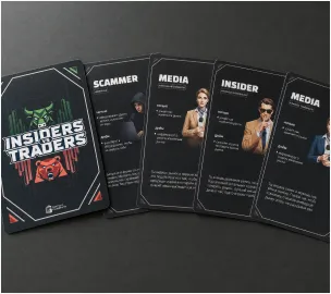 A fan of Insiders vs Traders role cards on a dark surface.